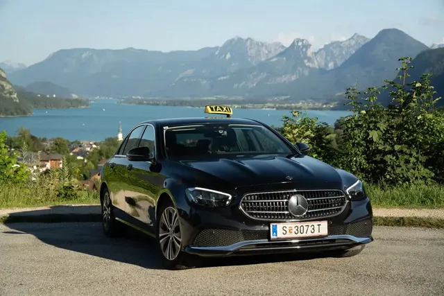 Mercedes E-Class taxi with Wolfgangsee and the mountains behind